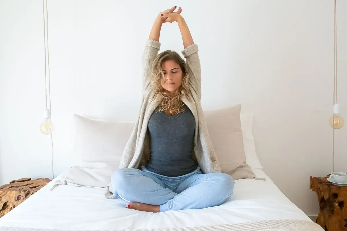 Person stretching in soft morning light as part of a calm routine