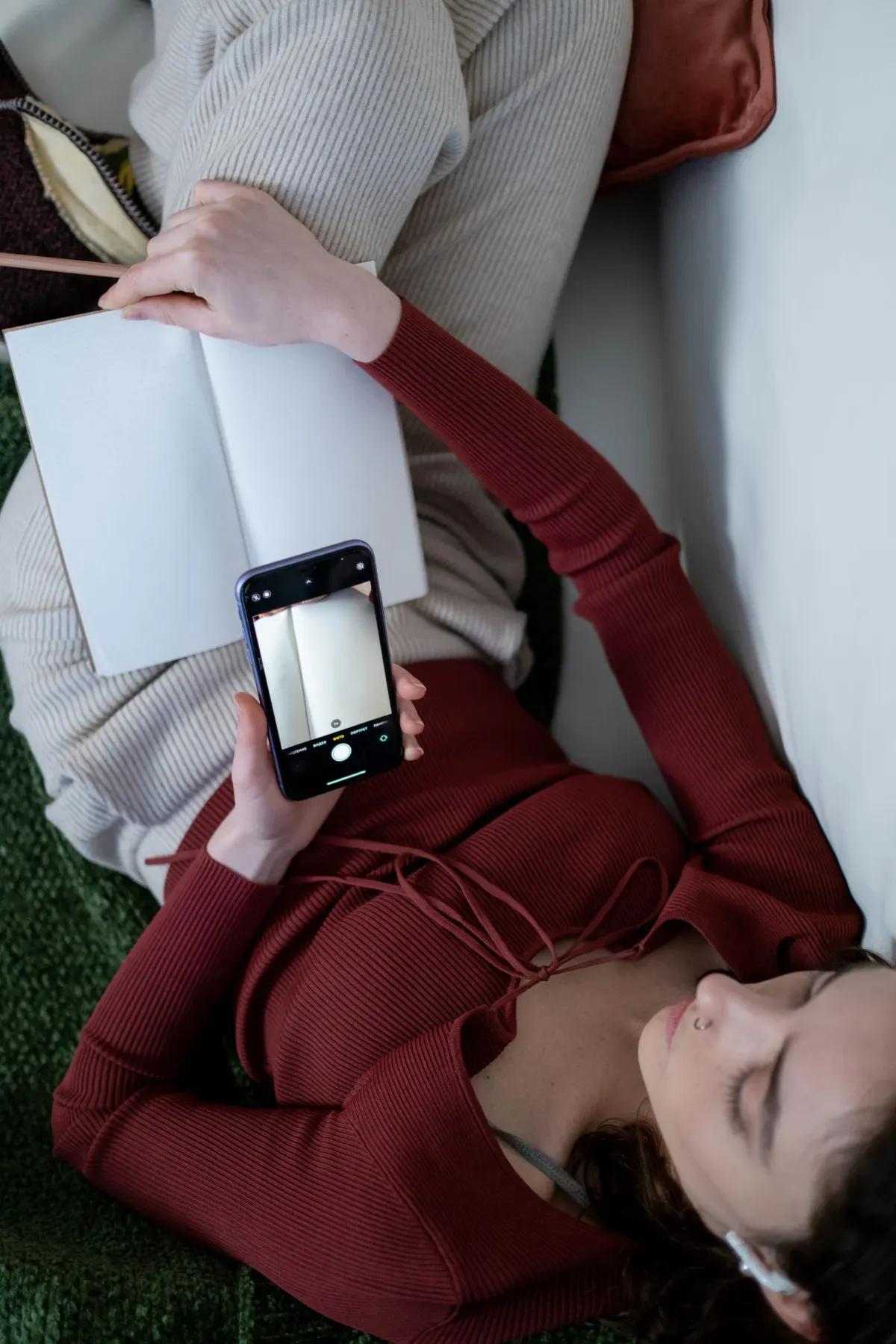 Person with a phone and notebook doing a self-care routine