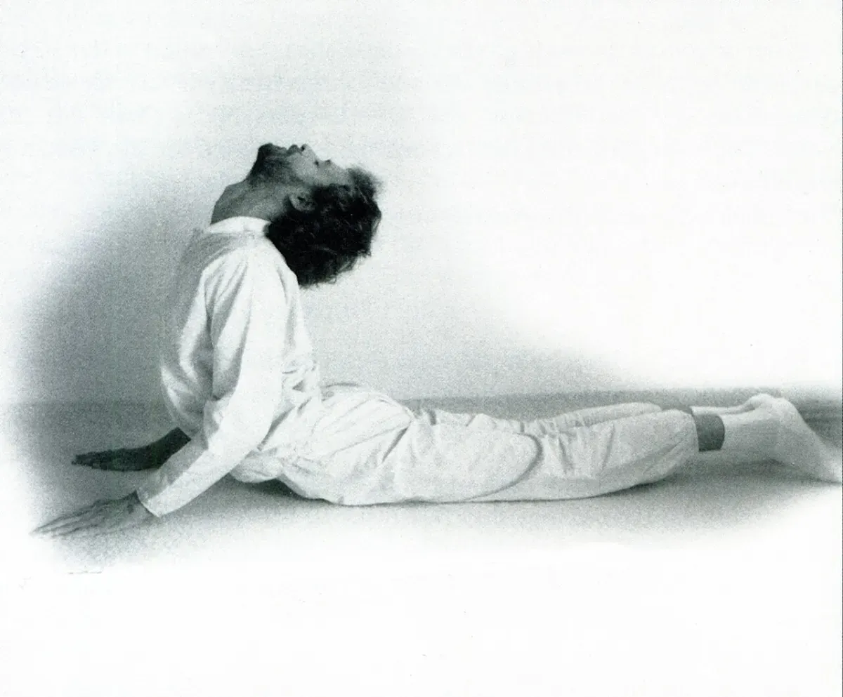 A person performing a doorway chest stretch to correct rounded shoulders