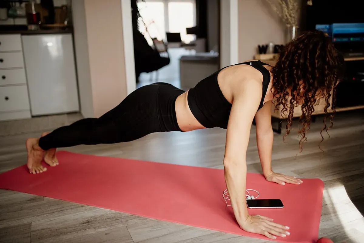 Plank held at home on a yoga mat, a core exercise
