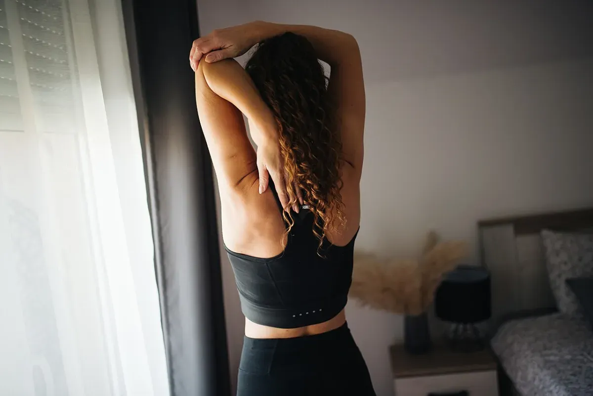 Overhead shoulder and upper back stretch seen from behind