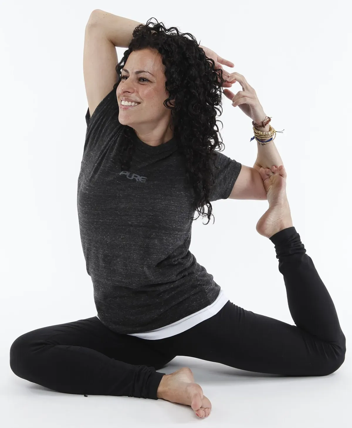 A person performing a deep glute stretch on a yoga mat