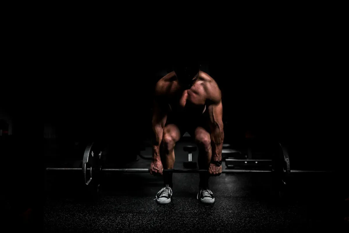 Person resting on gym equipment during a workout session