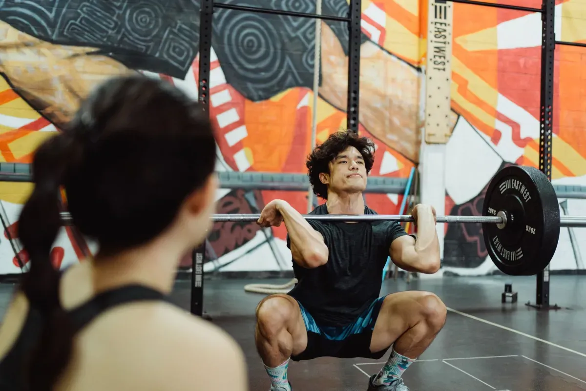 A focused lifter pushing through a hard set, the moment workout motivation quotes are meant for