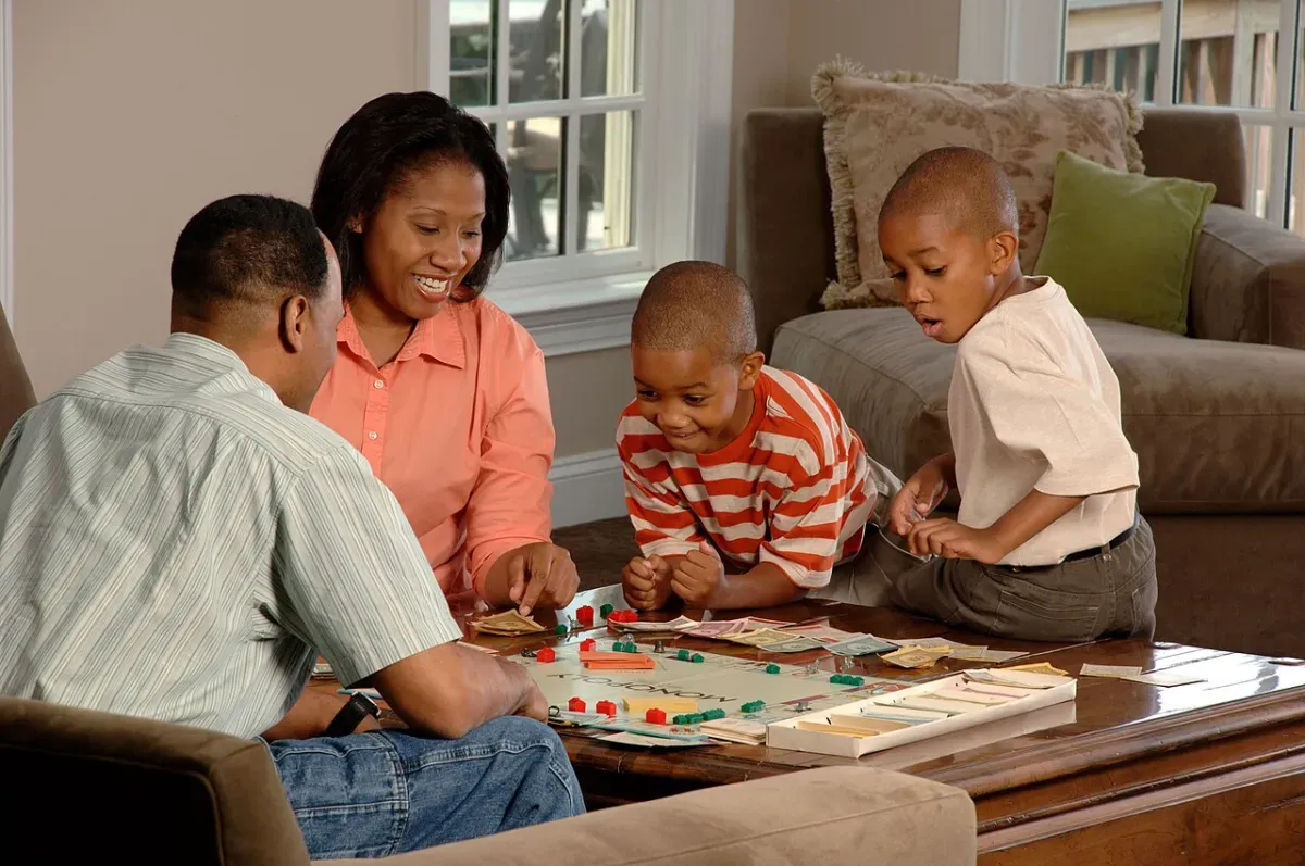 A family playing a board game together at home, the kind of shared play Habitica parties tried to capture