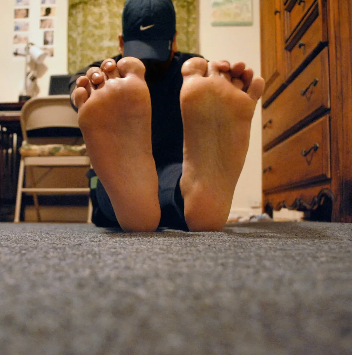 A runner in a seated forward bend, reaching toward an extended foot to stretch the hamstrings