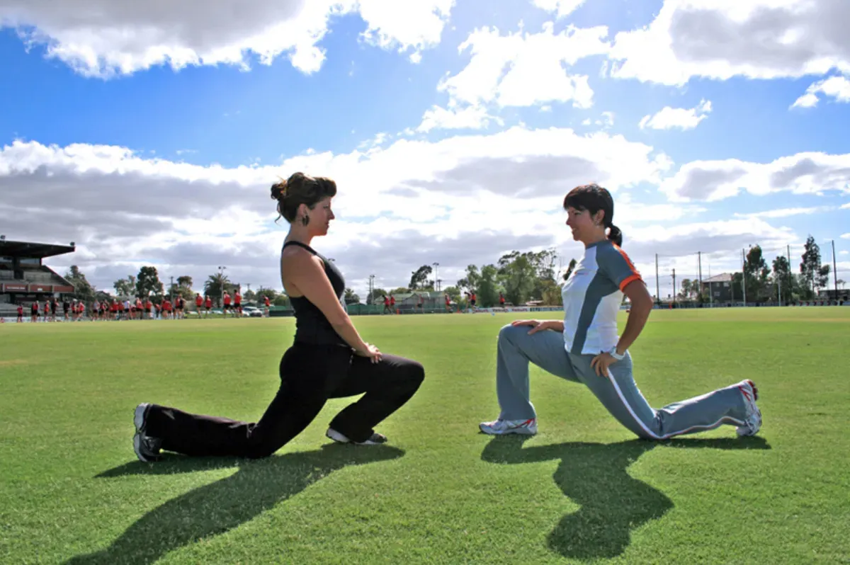 Person doing a forward lunge outdoors, a position that opens the hip flexors