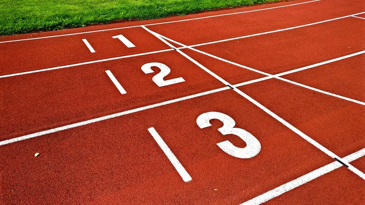 Numbered lanes 1, 2 and 3 on a red running track, a simple place to measure your steps per mile