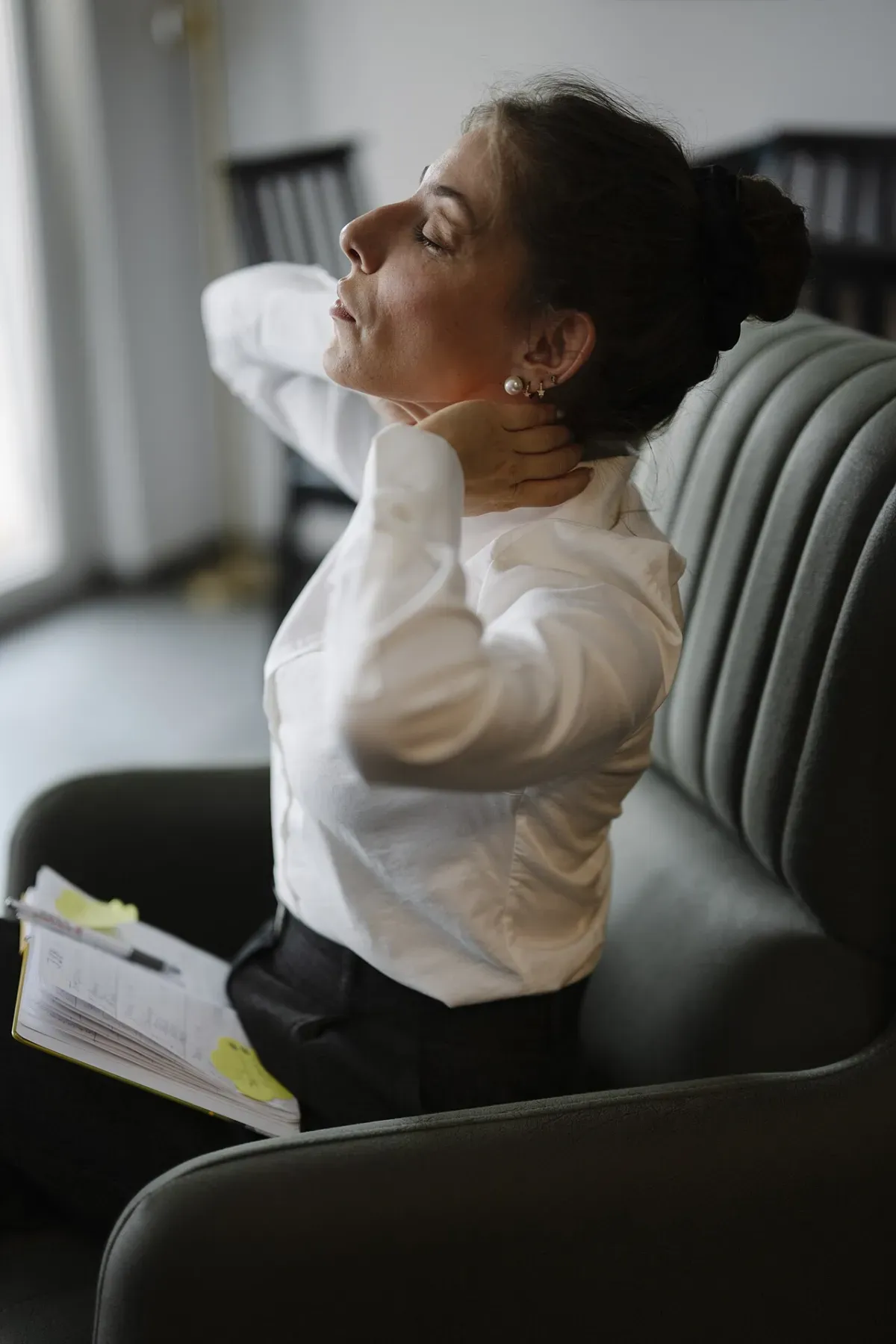 Seated trap and neck stretch done in a chair during a work break