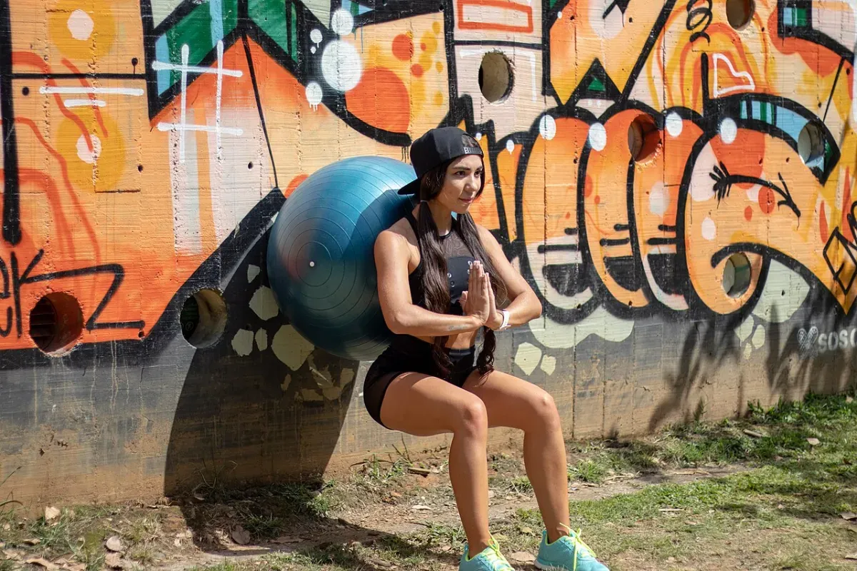 Wall-supported squat hold against a wall during a home leg workout