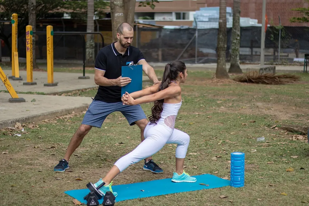 Shoulder stretch demonstrated by a personal trainer for a beginner flexibility routine