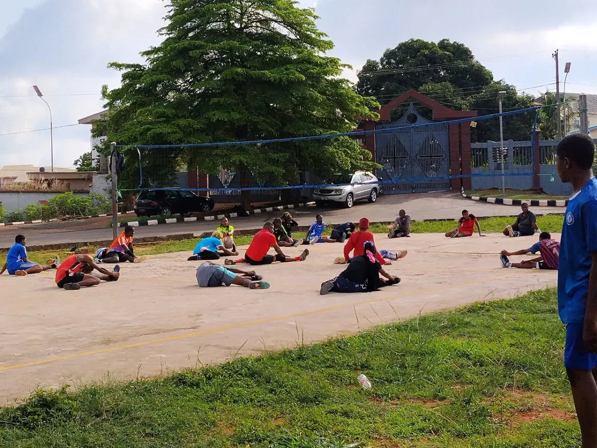 Neck stretch performed by a group as part of a warm-up routine