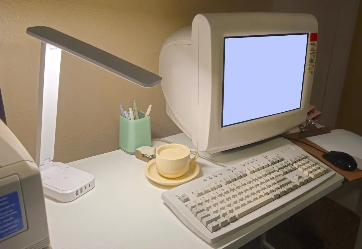 A nostalgic home office with a vintage computer where you might browse virtual pet sites