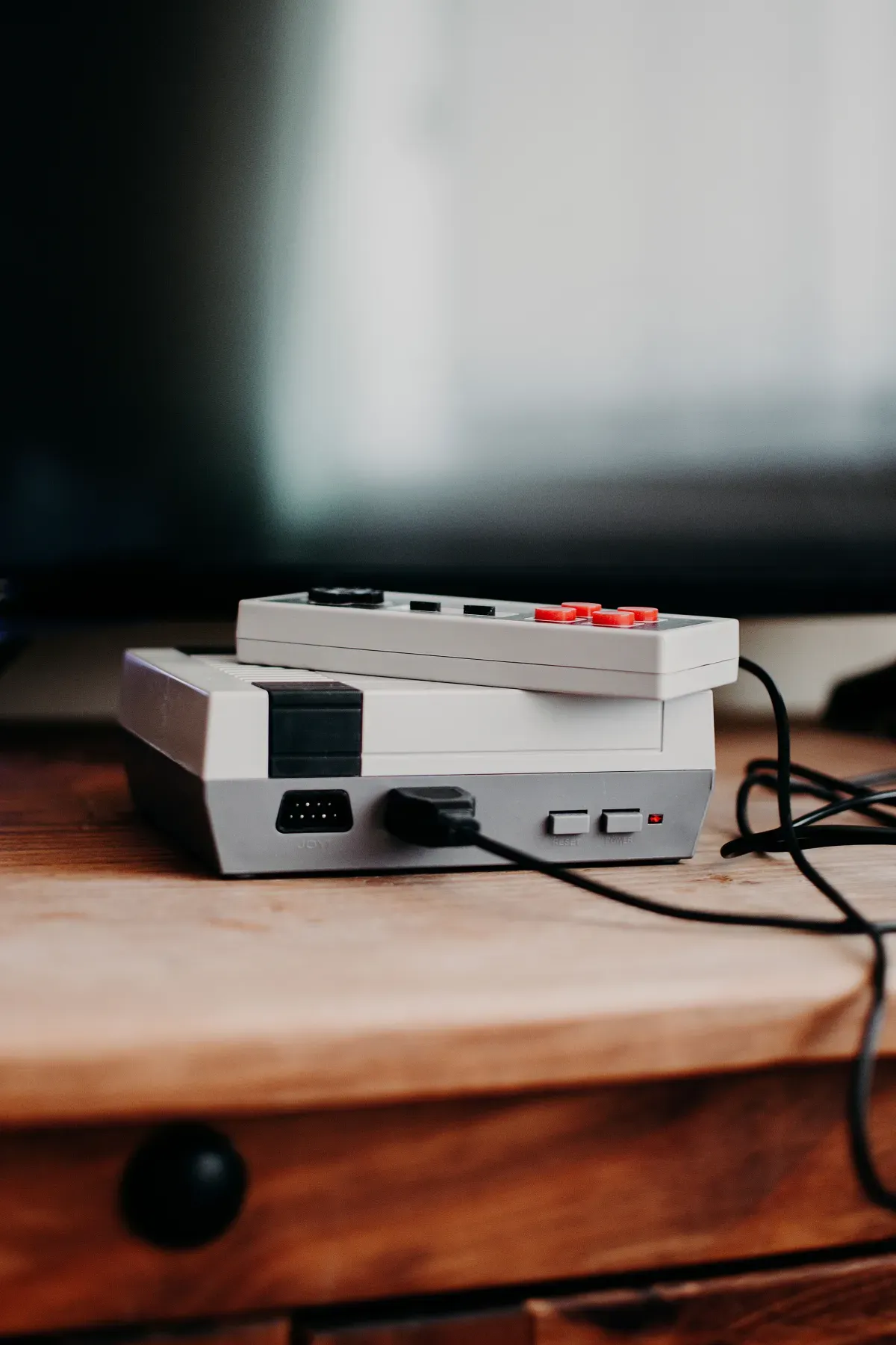 A vintage gaming console on a wooden desk, the era these virtual pet sites came from