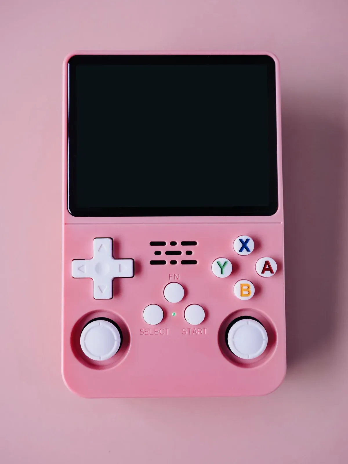 A pastel retro-style handheld gaming device on a soft background