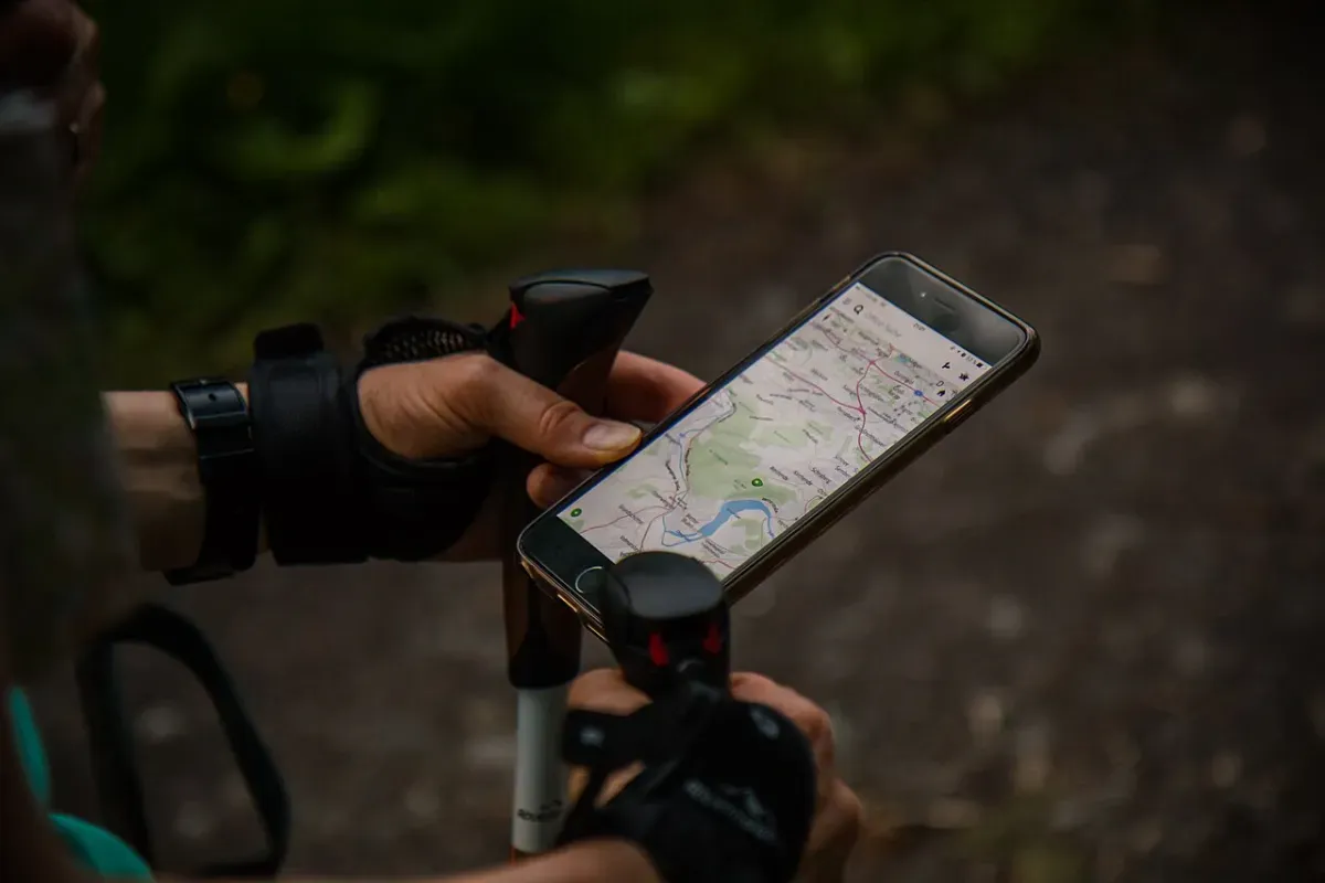 A walker checking a GPS route map in a walking app on a smartphone