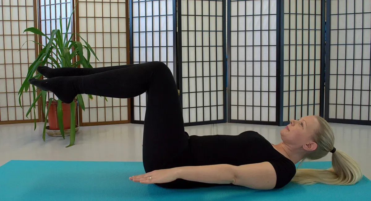 A person performing a wall pilates workout at home